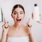 Female pointing at two shampoo bottles