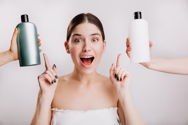 Female pointing at two shampoo bottles