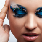 Girl with blue eye shadow and accessories on eyebrows